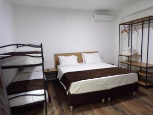 a bedroom with a bed and two bunk beds at Hotel Nord Est in Riccione