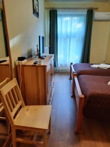 a bedroom with a bed and a desk with a computer on it at Ágnes Vendégház in Tokaj