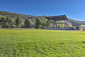 duże pole trawy z budynkiem w tle w obiekcie Newly Upgraded Avon Condo with Pool and Hot Tub Access w mieście Avon