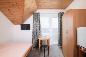 a bedroom with a bed and a desk and a window at Chyba Wyspa, Ostrowo in Ostrowo