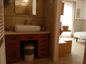 a bathroom with a sink and a mirror at Locazione turistica - B&B- Cocodè in Miane