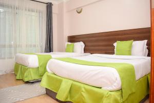 Postel nebo postele na pokoji v ubytování RAVIC HOMES NAKURU