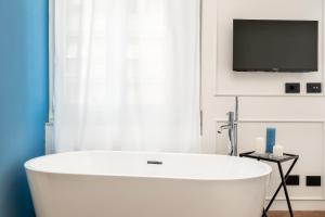 Televízia a/alebo spoločenská miestnosť v ubytovaní Nelli Rooms Via Veneto