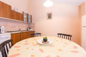 a kitchen with a table with a plate on it at Apartman studio Dino Klimno in Klimno +16 photos