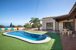 a swimming pool in the yard of a house at Villa Tazana in Icod de los Vinos