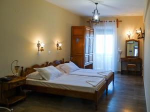 a bedroom with a large bed in a room at Elena Apartments in Psili Ammos