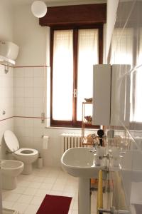 a white bathroom with a toilet and a sink at Pino Marittimo in Civitanova Marche