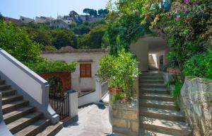 a stairway leading up to a house with stairs at Casa Fornillo in Positano