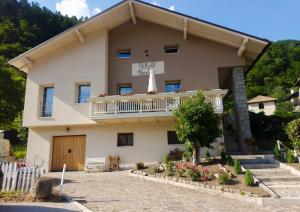 a large house with a balcony on top of it at B&b Villa Paradiso in Mezzana