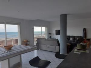 a living room with a view of the ocean at T4 Front de mer Valras Plage in Valras-Plage