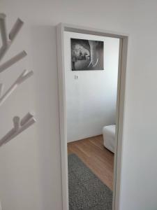 a mirror in a room with a picture on the wall at B30 Apartman in Budapest