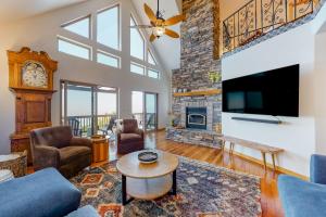 a living room with a fireplace and a tv at Million Dollar Mountain View in Crestline