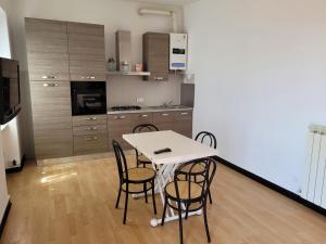 a kitchen with a table and chairs in a room at Solarolo Village in Moneglia