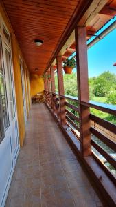 an empty hallway of a house with a porch at pensiunea Montana Sapinta in Săpînţa