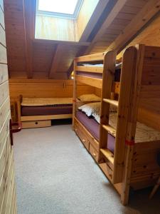 a room with two bunk beds in a cabin at Chalet Orchis in Hasliberg Wasserwendi