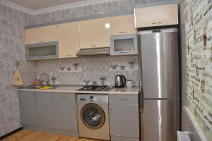 a kitchen with a refrigerator and a washing machine at Villa_Nihad in Gabala