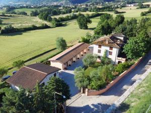 an aerial view of a house in a field at Santa Croce in Fossato di Vico