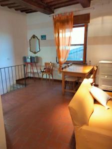 a living room with a couch and a table at vista sulla vallata in Pitigliano +11 photos