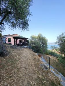 a house on a hill next to the water at Villa Il Pettirosso in La Spezia