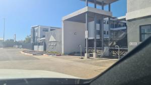 a view of a building from the side of a car at Sarona Studio F103 in Gaborone