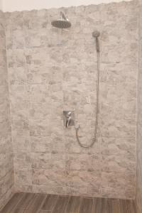 a bathroom with a shower with a stone wall at Penzion YORK in Liberec