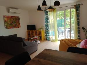 a living room with a couch and a table at Villa perpignanaise in Perpignan