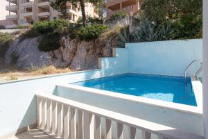 a swimming pool on the side of a building at Apartments Alajbeg in Trogir