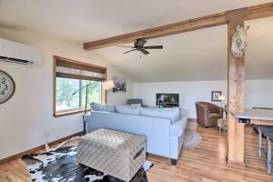 a living room with a blue couch and a table at Lovely Barn Loft with Mountain Views on Horse Estate in Fort Collins