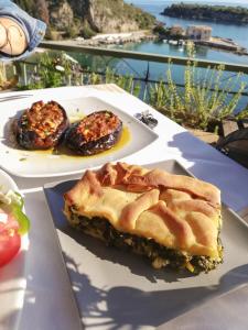 a table with two plates of food on it at Palataki in Kardamili