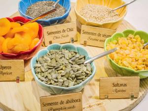 a table with bowls of different types of nuts and seeds at Hotel Ibis Lisboa Sintra in Sintra
