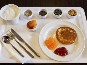 a white tray with a plate of pancakes and other ingredients at Hotel Ibis Lisboa Sintra in Sintra
