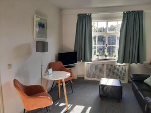 a living room with a couch and a table at BergOpwaerts in Sint Odiliënberg