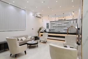 a living room with a couch and chairs at شقق كلاس للشقق المخدومة اقتصادي in Hail