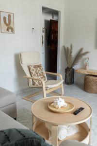 a living room with a coffee table and a chair at LXR Waikiki Beach Front 3Hab. Tarifa in Tarifa