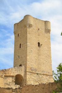 a tall brick tower on top of a building at Palataki in Kardamyli