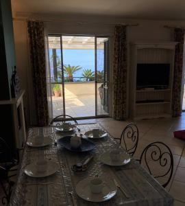 a dining room table with a view of the ocean at Taormina Helas Apartment by Taormina Holidays in Taormina
