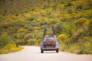 a small car with two people on the back on a road at Palataki in Kardamyli