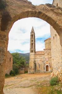 an old stone building with a clock tower at Palataki in Kardamyli