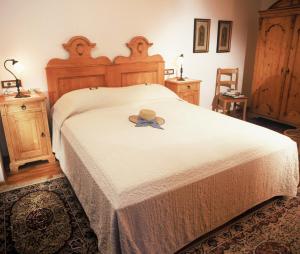 a bedroom with a bed with a hat on it at Apartments Bledea in Bled