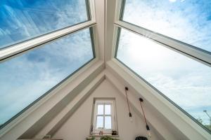 a room with three windows in the ceiling at Deluxe Trafo-Haus in Bad Segeberg