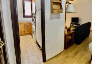 a kitchen with a white refrigerator and a table at APARTAMENTO SAPPORO VIELHA in Vielha