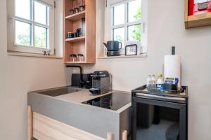 a small kitchen with a sink and a stove at Deluxe Trafo-Haus in Bad Segeberg