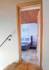 a bedroom with a bed and a open door at Apartment Muretto in Bašanija