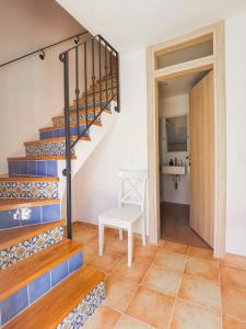a stairway with a white chair in a room at Apartment Muretto in Bašanija