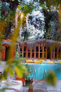 a house with a swimming pool in front of it at Kayserkaya Cottages in Selcuk