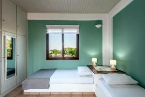 A bed or beds in a room at ApteraMare Tradidtional house 'New listing'