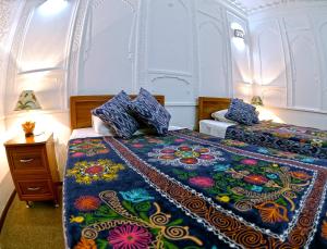Ένα ή περισσότερα κρεβάτια σε δωμάτιο στο Minzifa Inn