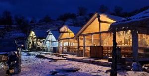 a building with snow on it at night at Camping Cajupi in Gjirokastër