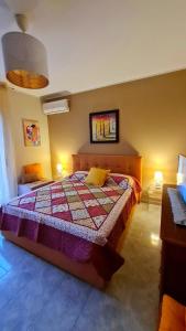 a bedroom with a bed with a quilt on it at Casa Vacanze La Melagrana in Modica