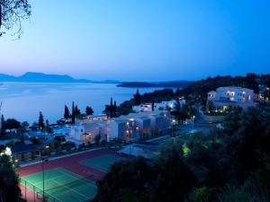 a town with a tennis court at night at Porto Galini Seaside Resort & Spa in Nikiana